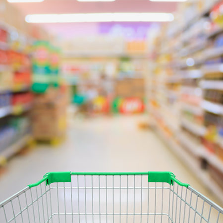 Supermarket interior with shopping cart